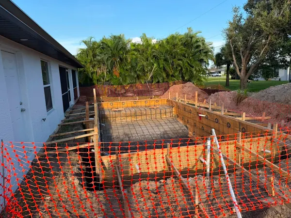 Wooden forms and steel reinforcement around an excavated pool